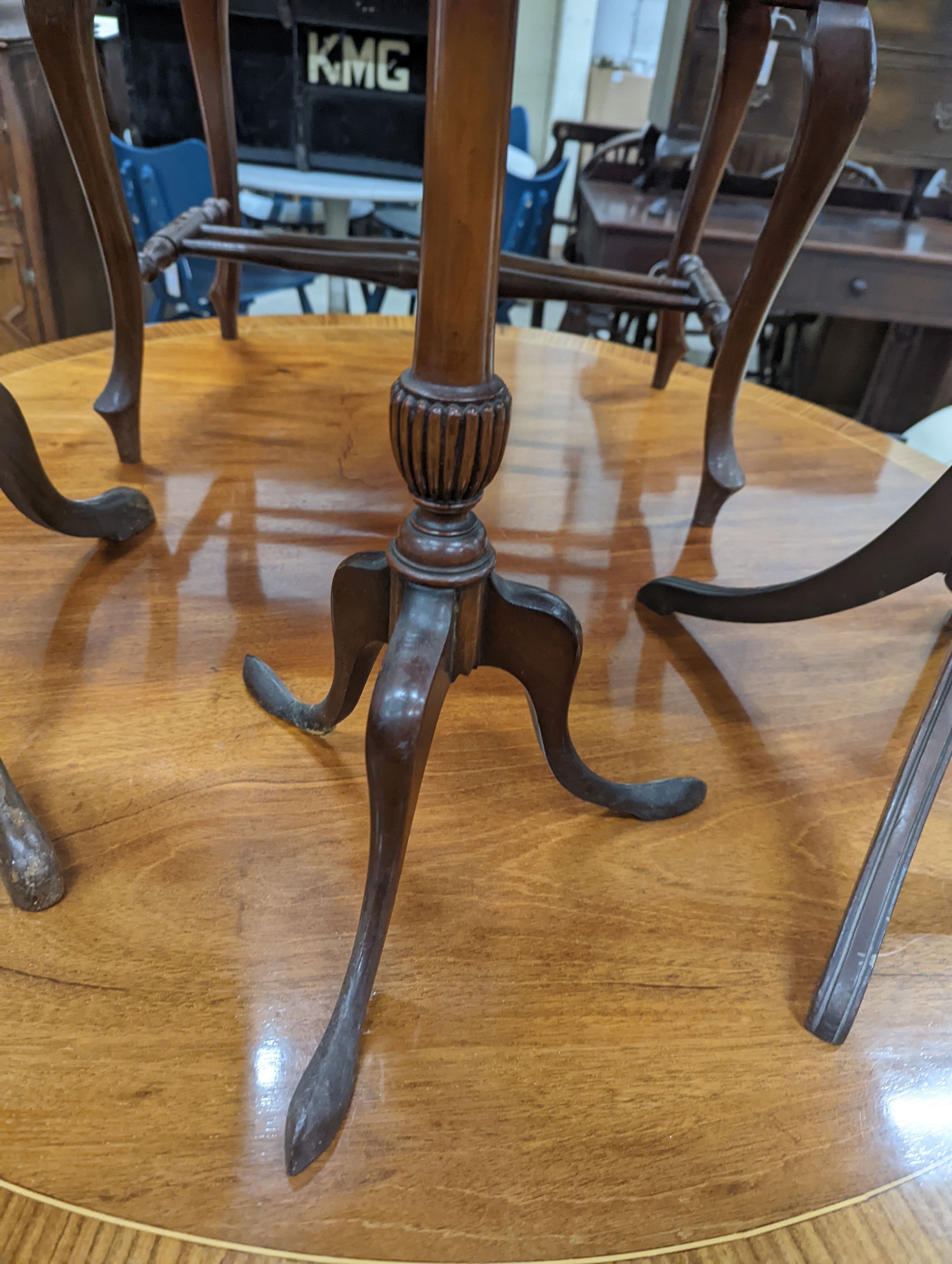 Two Edwardian inlaid mahogany tripod wine tables, larger height 50cm, together with a later folding oval wine table (3)